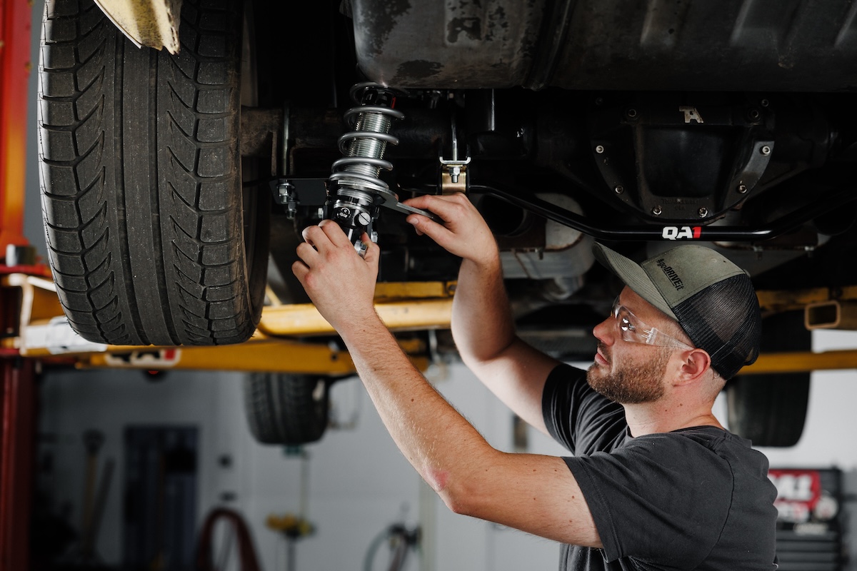 Mechanic checking suspension height after lift kit fitment