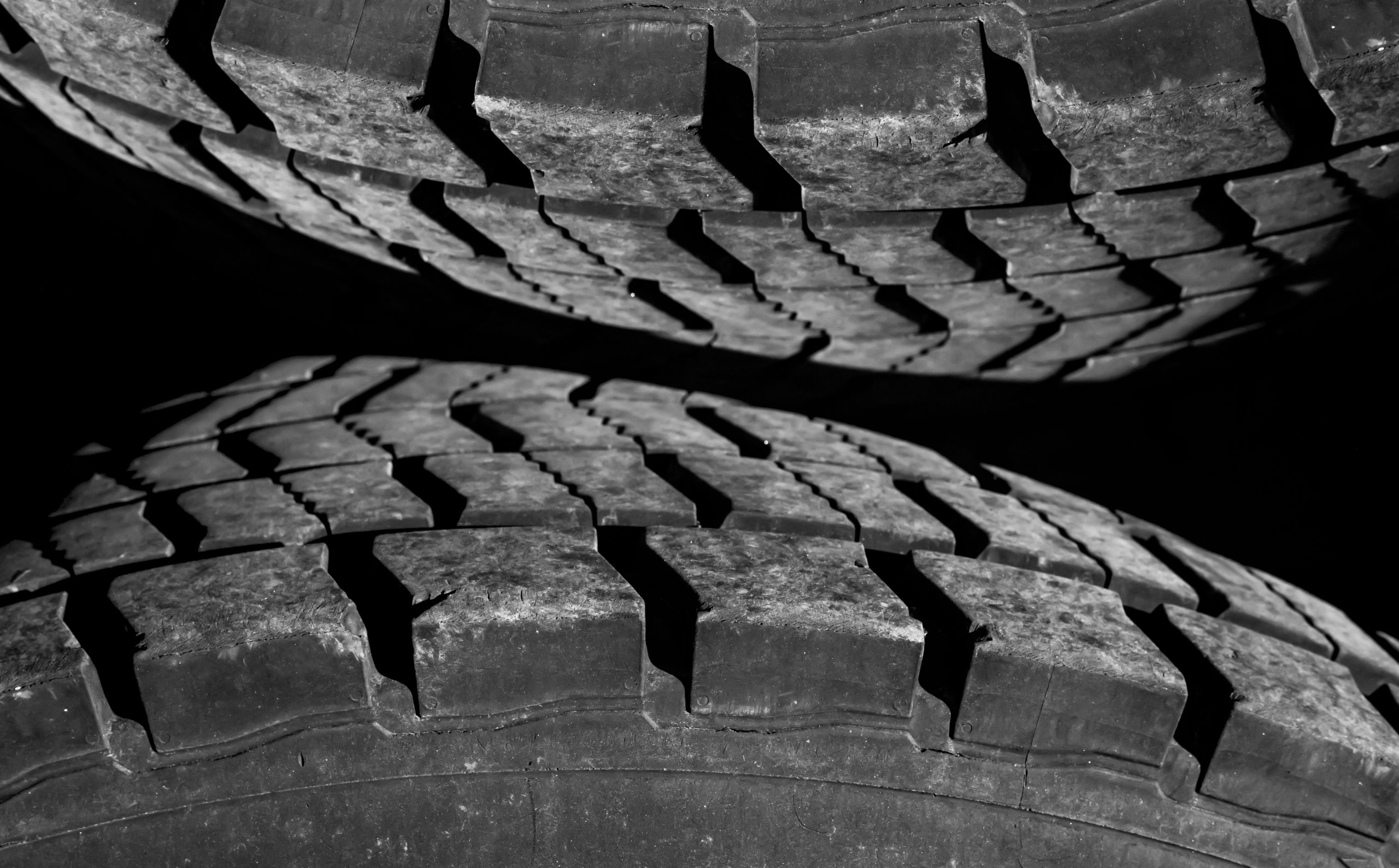 Close-up comparison of an HT and AT tyre side by side, showing the tread difference clearly